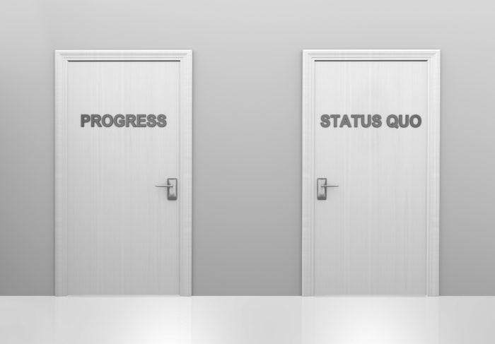 Two doors saying progress and status quo