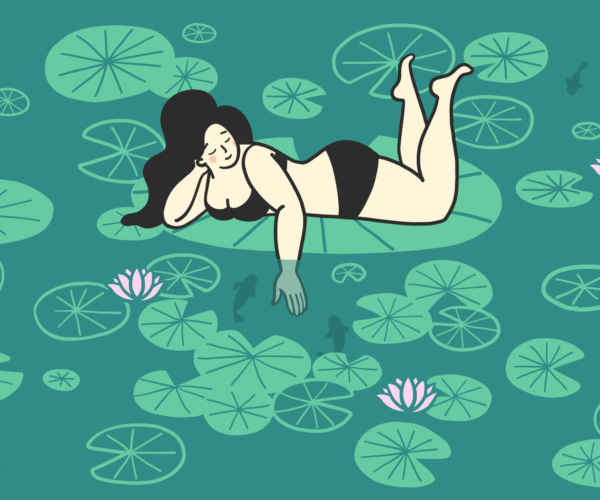 Woman in a two piece bathing suit is laying on an lilypond.