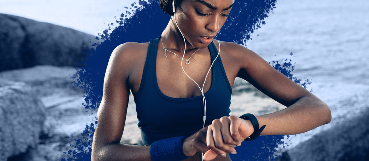 Women checking her smartwatch while exercising