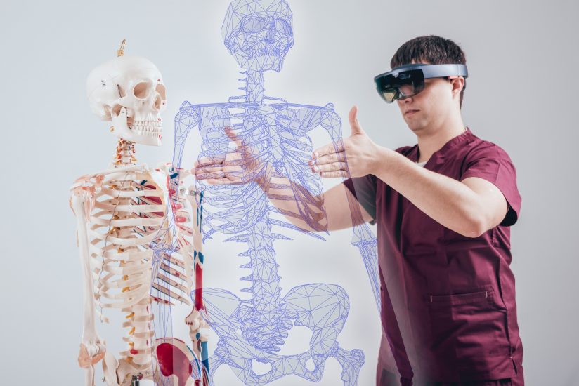 Advancements in AR and VR have allowed physicians to complete in-depth training; in this example, a physician uses virtual reality to learn the skeletal system of the human body.