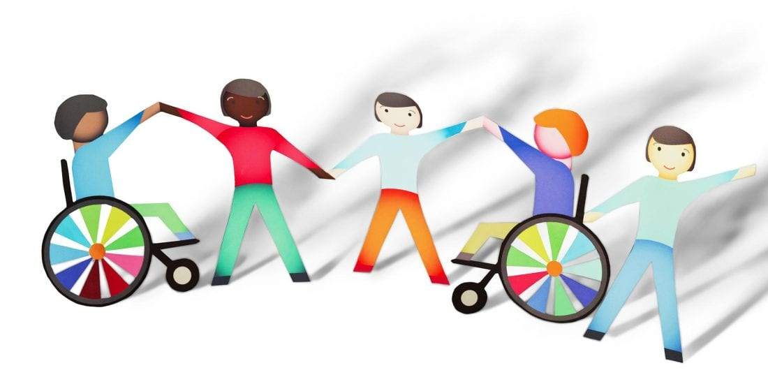 Image of people holding hands with some being in wheel chairs.