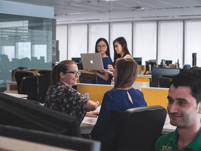  People in an office environment working. 