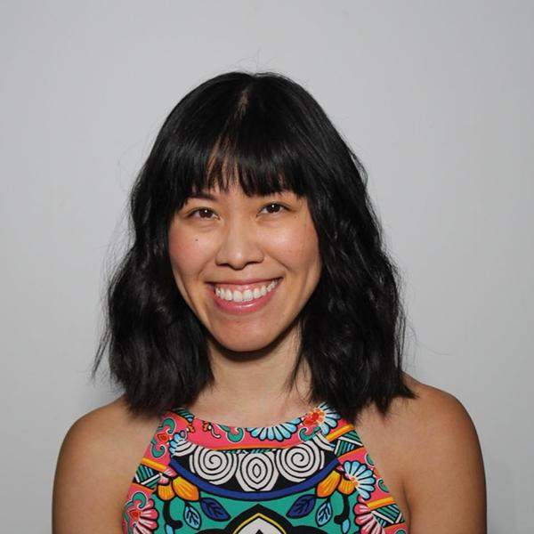 Headshot of Grace Phang in a colorful printed top.