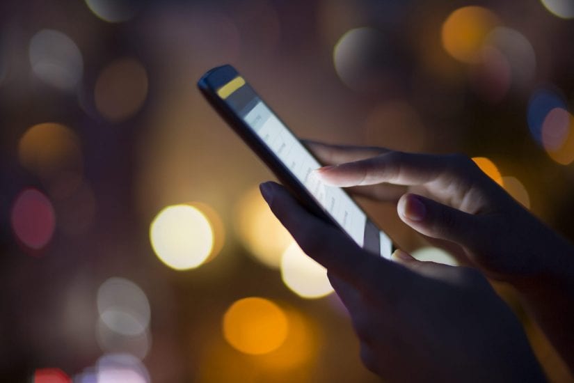 woman using touch screen phone