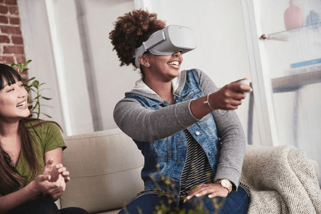 Woman playing with the Oculus Go Virtual Reality all-in-one headset