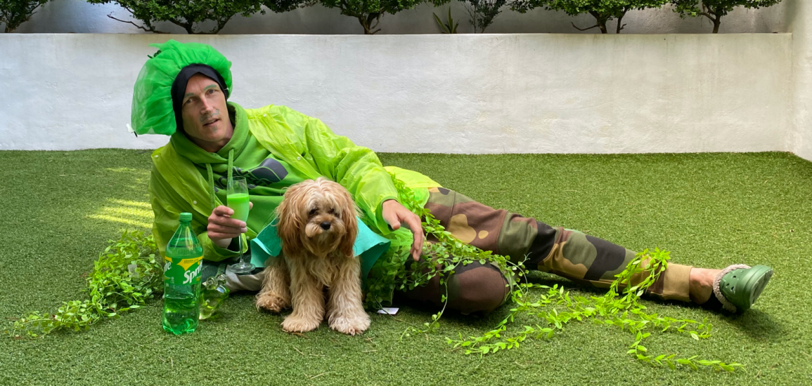 Guy Ligertwood poses with his dog in a St. Patrick's Day costume.