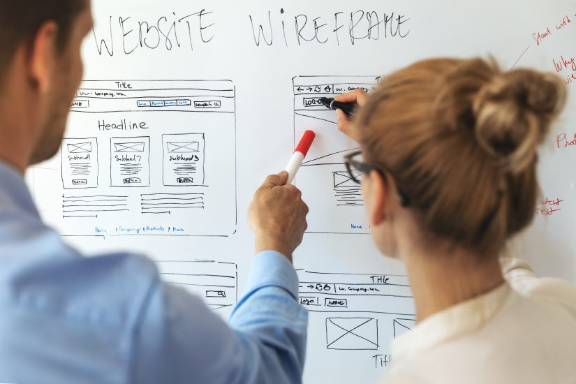 UI/UX designers working on new website wireframe. 