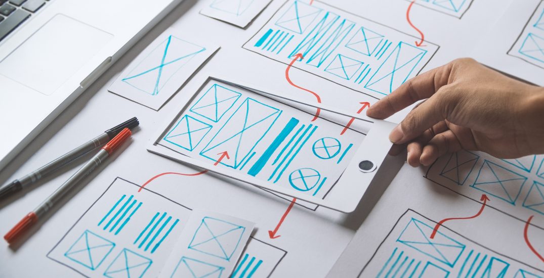 Photo of UX wireframes showing movement through mobile app design.