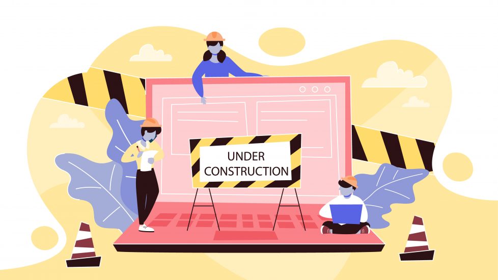 Illustration of laptop with three illustrated people and an “under construction” sign.