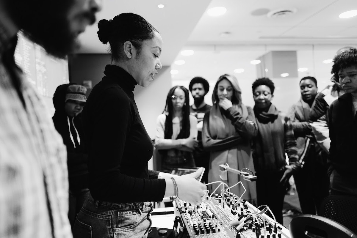 Ari Melenciano talks with participants at the School of Afrotectopia event in New York City, January 2020.