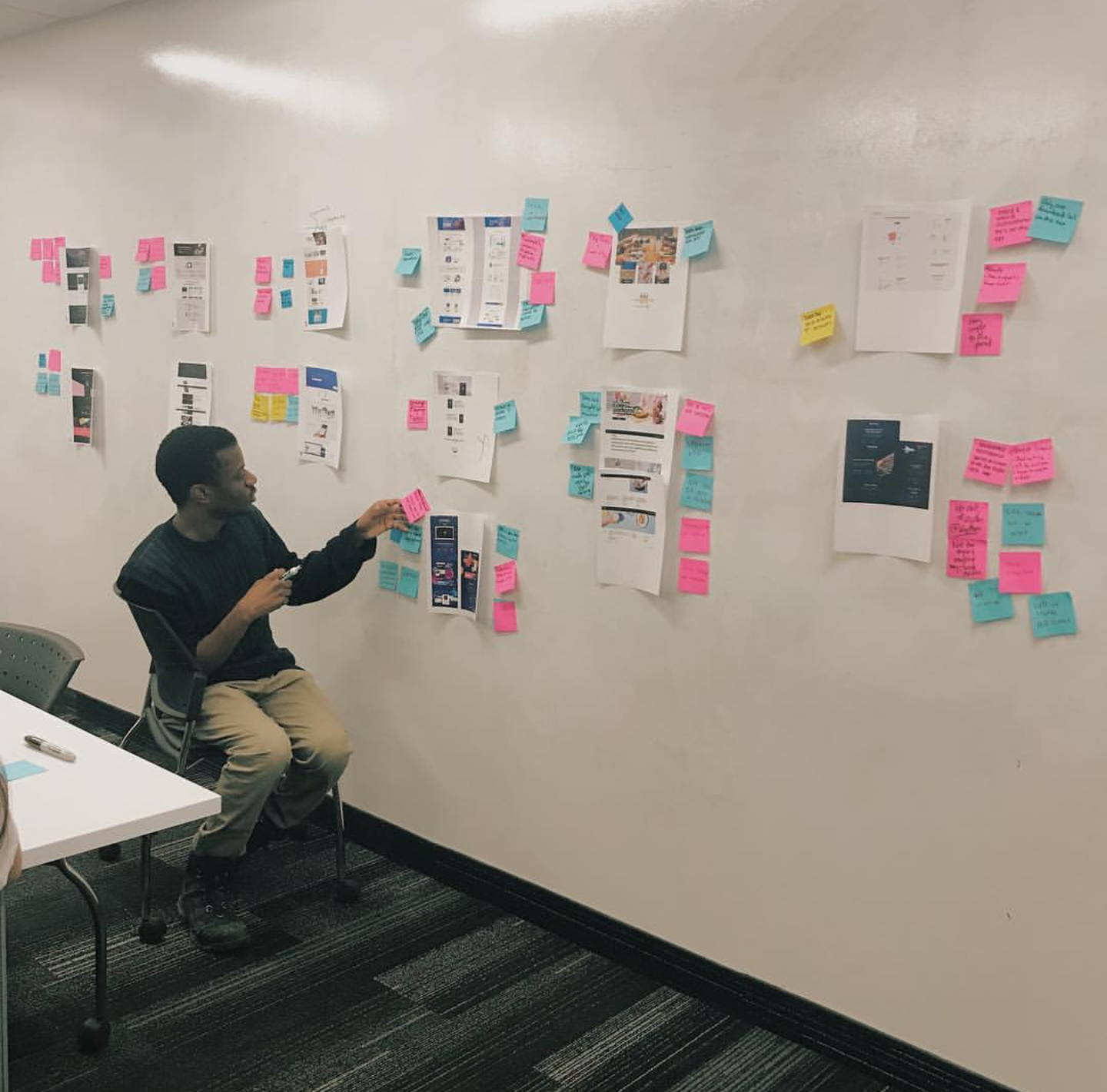  Mackenzie Derival working on a UX project in a design studio setting.